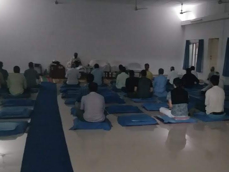 This is a specially poorly lit photograph but it’s the only one I’ve got from the meditation hall. Plain white walls and at the front you’ll find the teacher’s chairs and sound equipment. Of the nine rows of cushions, only six are left. The picture is not mine but ended up in my Whatsapp folder somehow and I’m hoping the owner won’t mind me reproducing it here.